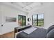 Modern bedroom with stylish furniture, large windows, tray ceilings and hardwood flooring at 4624 Pompano St, Placida, FL 33946