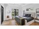 Modern bedroom with stylish furniture, large windows, tray ceilings and hardwood flooring at 4624 Pompano St, Placida, FL 33946
