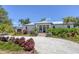 A stunning home with meticulous landscaping, a circular driveway, and a grand entrance at 4624 Pompano St, Placida, FL 33946