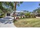 Charming home with a well-manicured lawn, beautiful landscaping, and a spacious driveway at 4624 Pompano St, Placida, FL 33946