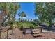 Outdoor community garden with raised beds, picnic benches, and lush tropical landscaping at 4624 Pompano St, Placida, FL 33946