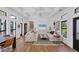 Bright living room with white couches, coffered ceilings, hardwood floors and many windows at 4624 Pompano St, Placida, FL 33946