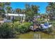 A waterfront home with a private dock and boat lift, surrounded by lush landscaping and blue skies at 4624 Pompano St, Placida, FL 33946