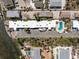 Aerial view of the condominium complex with a pool and bay access at 5055 N Beach Rd # 208, Englewood, FL 34223