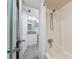 A bathroom with a shower and tub combo, and a door open to the sink at 5055 N Beach Rd # 208, Englewood, FL 34223