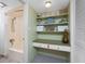 The bathroom has shelving with towels and decorative accents at 5055 N Beach Rd # 208, Englewood, FL 34223