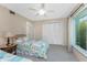 A bedroom featuring two twin beds, closet, and a window with natural light at 5055 N Beach Rd # 208, Englewood, FL 34223