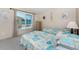 A room featuring two twin beds, a dresser, and a large window for natural light at 5055 N Beach Rd # 208, Englewood, FL 34223