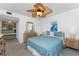 Comfortable bedroom features a queen bed, ceiling fan, and adjacent closet area at 5055 N Beach Rd # 208, Englewood, FL 34223