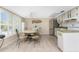 Open-concept kitchen and dining area is bathed in natural light from the many windows at 5055 N Beach Rd # 208, Englewood, FL 34223