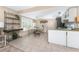 Bright eat-in kitchen with neutral tile, stainless fridge, and outdoor views through plantation shutters at 5055 N Beach Rd # 208, Englewood, FL 34223
