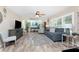 Spacious living room with new plank flooring, neutral paint colors, and bright, natural light at 5055 N Beach Rd # 208, Englewood, FL 34223