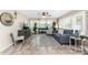 Inviting living room features wood floors, ceiling fan, comfortable seating, and view to the lanai at 5055 N Beach Rd # 208, Englewood, FL 34223