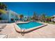 Relaxing pool area with lounge chairs and tables and neatly kept landscaping at 5055 N Beach Rd # 208, Englewood, FL 34223