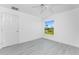 Bright bedroom with ceiling fan and large window overlooking a waterway at 5232 Conner Ter, Port Charlotte, FL 33981