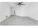 A brightly lit and spacious bedroom has new gray flooring and a ceiling fan at 5232 Conner Ter, Port Charlotte, FL 33981