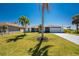 Well-maintained single-Gathering home with lush lawn, mature palms, and inviting curb appeal at 5232 Conner Ter, Port Charlotte, FL 33981