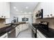 Bright kitchen boasts white cabinets, granite countertops, and stainless steel appliances at 5232 Conner Ter, Port Charlotte, FL 33981