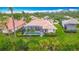 An aerial shot shows the well-manicured lawn and landscaping surrounding a screened-in pool at 5433 White Ibis Dr, North Port, FL 34287