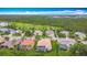 Scenic aerial view of homes, a golf course, and a dense canopy of trees in this tropical community at 5433 White Ibis Dr, North Port, FL 34287