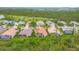 An elevated perspective of homes with tropical landscaping, golf course, and a dense tree canopy at 5433 White Ibis Dr, North Port, FL 34287