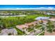 Stunning aerial view of the community showcasing a golf course, a lake, and beautiful homes with well-manicured lawns at 5433 White Ibis Dr, North Port, FL 34287