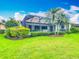 View of the backyard with a screened-in pool, patio, and well-maintained landscaping at 5433 White Ibis Dr, North Port, FL 34287