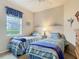 Bright bedroom with two twin beds, a view to the exterior and beach-themed decorations at 5433 White Ibis Dr, North Port, FL 34287