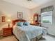 Bedroom featuring window, plush bedding, and dresser with mirror at 5433 White Ibis Dr, North Port, FL 34287
