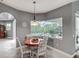 Breakfast nook with table set and a bright window overlooking the pool area at 5433 White Ibis Dr, North Port, FL 34287