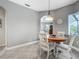 Breakfast nook with gray walls, tile floor, arched entry, and a charming chandelier at 5433 White Ibis Dr, North Port, FL 34287
