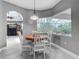 Cozy breakfast nook with table, chairs, arched doorway, and pool view at 5433 White Ibis Dr, North Port, FL 34287