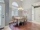 Bright dining room with hardwood floors, chandelier, and large window providing natural light at 5433 White Ibis Dr, North Port, FL 34287