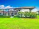 The backyard features a lush lawn, manicured shrubs, and a screened-in lanai at 5433 White Ibis Dr, North Port, FL 34287