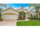 Well-maintained single-story home with a neutral color scheme, brick paver driveway, and lush landscaping at 5433 White Ibis Dr, North Port, FL 34287