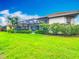 Beautiful lawn, flowering shrubs, and screened-in lanai enhance the backyard of this home at 5433 White Ibis Dr, North Port, FL 34287