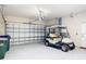 Spacious garage with ample storage and a golf cart parked inside, perfect for golf enthusiasts at 5433 White Ibis Dr, North Port, FL 34287