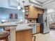 Bright kitchen featuring stainless steel appliances, tile flooring and bar seating at 5433 White Ibis Dr, North Port, FL 34287
