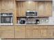 Kitchen featuring wooden cabinets, stainless steel microwave and countertop appliances at 5433 White Ibis Dr, North Port, FL 34287
