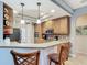 Well-lit kitchen with wood cabinetry, breakfast bar, and modern appliances for convenient cooking at 5433 White Ibis Dr, North Port, FL 34287