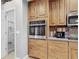 Spacious kitchen featuring stainless steel appliances, wooden cabinets and a pantry at 5433 White Ibis Dr, North Port, FL 34287