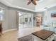 Open-concept living area with tile flooring, backyard access, and a view to the dining area at 5433 White Ibis Dr, North Port, FL 34287