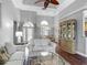 Open-concept living room with hardwood floors, neutral paint, and lots of natural light at 5433 White Ibis Dr, North Port, FL 34287