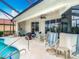 Relaxing covered patio area, with pool access, perfect for enjoying the beautiful weather at 5433 White Ibis Dr, North Port, FL 34287