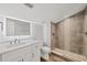 Modern bathroom featuring a sleek vanity with illuminated mirror and stylish walk-in shower with decorative tile accents at 6030 Boca Grande Cswy # B21, Boca Grande, FL 33921
