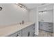 Modern bathroom with gray cabinets, sleek black hardware, and a pristine white countertop at 6030 Boca Grande Cswy # B21, Boca Grande, FL 33921
