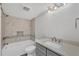 Well-lit bathroom featuring a tub, grey vanity, and tiled accent wall for a touch of elegance at 6030 Boca Grande Cswy # B21, Boca Grande, FL 33921