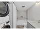 Contemporary bathroom showcasing a tub-shower combination, a modern vanity, and a stacked washer and dryer at 6030 Boca Grande Cswy # B21, Boca Grande, FL 33921