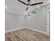 Unfurnished bedroom with wood-look flooring, a ceiling fan, and a modern, vaulted ceiling at 6030 Boca Grande Cswy # B21, Boca Grande, FL 33921
