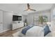 Bright bedroom with balcony access, ceiling fan, and modern dresser at 6030 Boca Grande Cswy # B21, Boca Grande, FL 33921